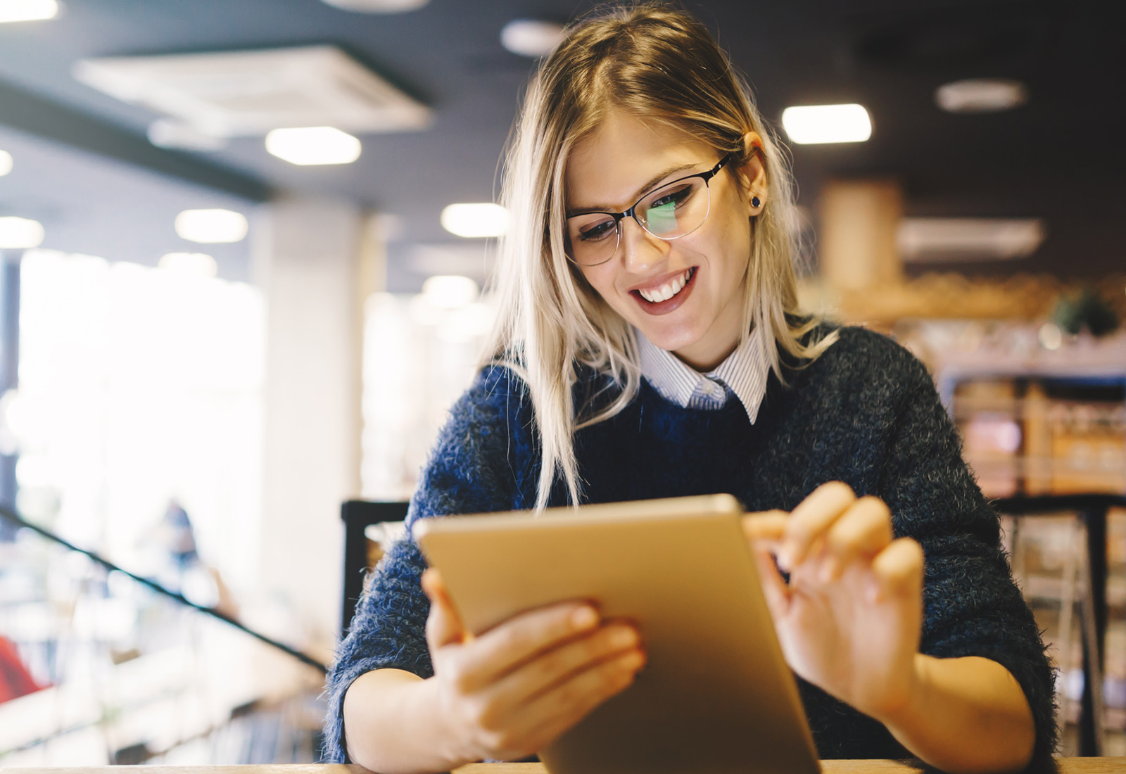 Female student on Ipad in library
